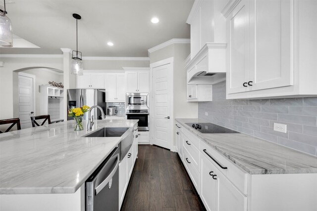 kitchen with a center island with sink, white cabinets, pendant lighting, and dark hardwood / wood-style floors