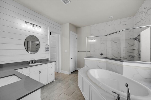 bedroom with crown molding, ceiling fan, ensuite bathroom, light colored carpet, and a tray ceiling