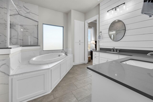 bathroom featuring separate shower and tub and vanity