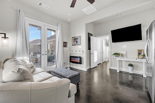 living room featuring ceiling fan and french doors