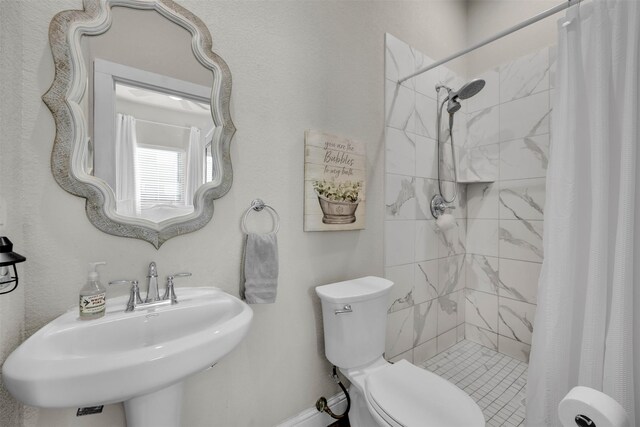 bathroom with sink, toilet, and a shower with shower curtain