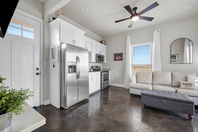 kitchen with white cabinets, stainless steel appliances, and a healthy amount of sunlight