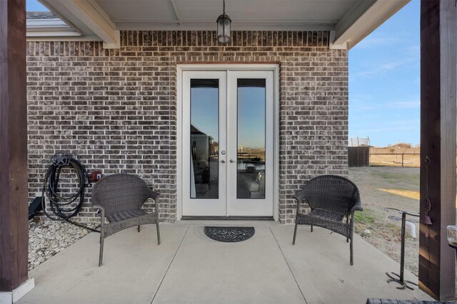 entrance to property featuring a patio and french doors