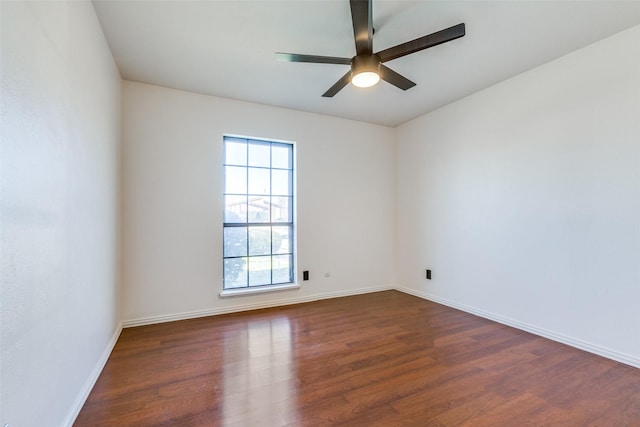 unfurnished room featuring ceiling fan, a wealth of natural light, and dark hardwood / wood-style floors