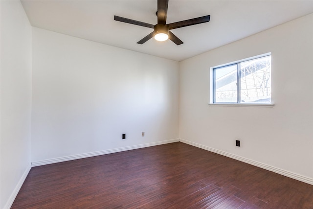 spare room featuring ceiling fan and dark hardwood / wood-style floors