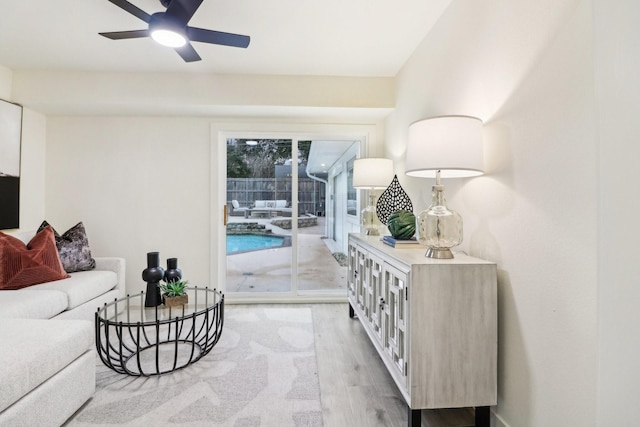 living room with ceiling fan and light wood-type flooring