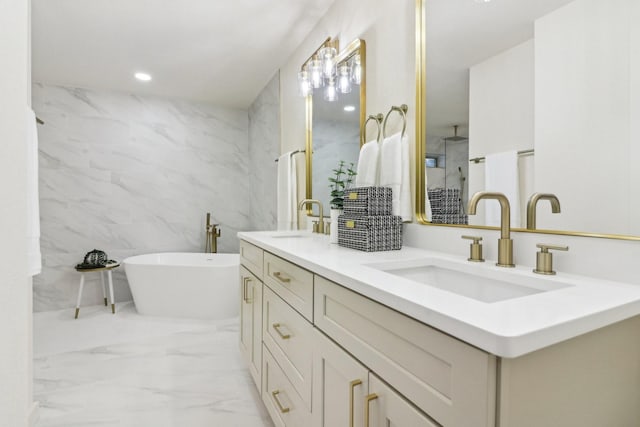 bathroom with a tub to relax in and vanity