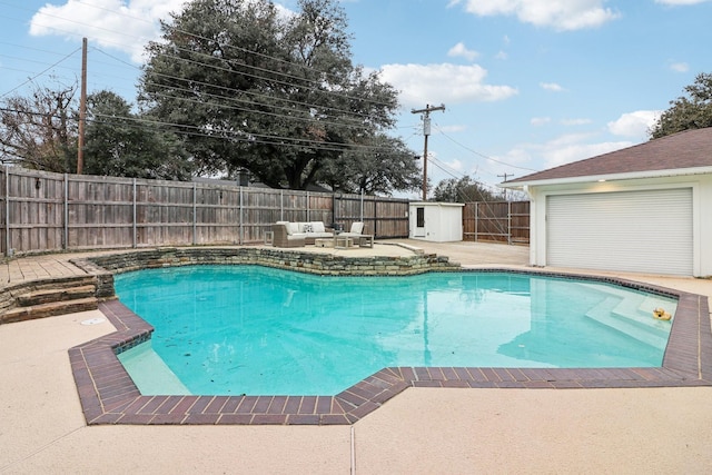 view of swimming pool featuring a storage unit and a patio area