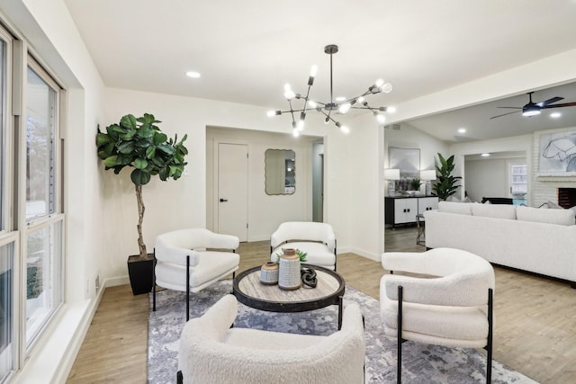 living room featuring a fireplace, a wealth of natural light, and light wood-type flooring