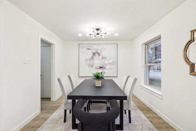 dining room with a chandelier and light hardwood / wood-style flooring