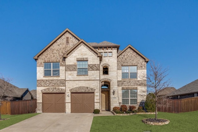 french country home featuring a garage, driveway, a front yard, and fence