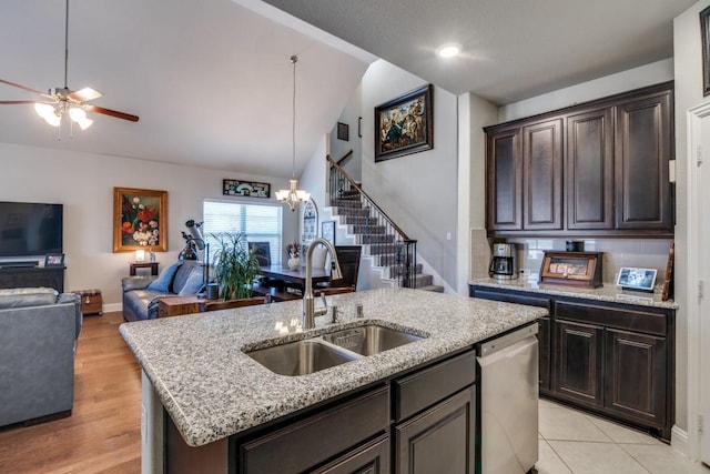 1625 Veneto Dr, Mclendon Chisholm, TX 75032 - kitchen featuring stainless steel dishwasher, a sink, dark brown cabinets, open floor plan, and vaulted ceiling