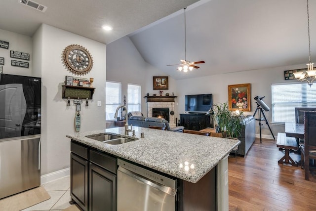 1625 Veneto Dr, Mclendon Chisholm, TX 75032 - kitchen featuring dishwasher, visible vents, a sink, baseboards, and a tiled fireplace