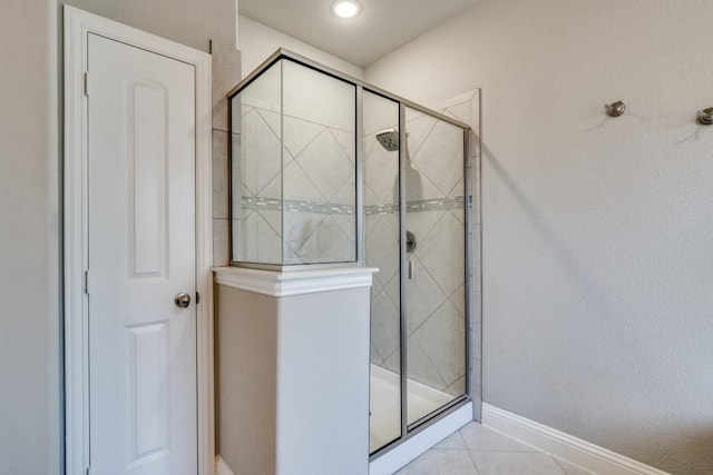 1625 Veneto Dr, Mclendon Chisholm, TX 75032 - bathroom featuring a shower stall, tile patterned flooring, and baseboards