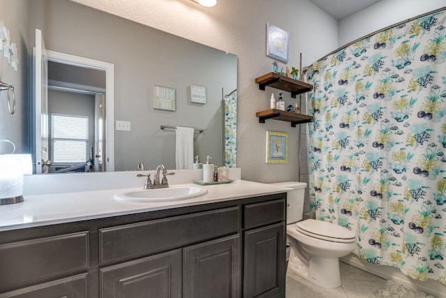 bathroom featuring tile patterned flooring, vanity, a shower with shower curtain, and toilet