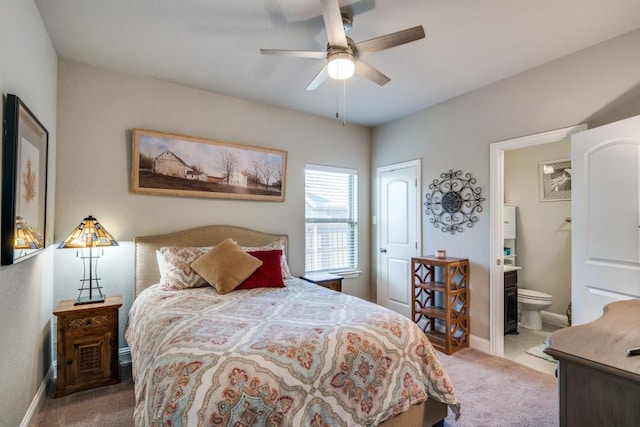 carpeted bedroom featuring connected bathroom and ceiling fan