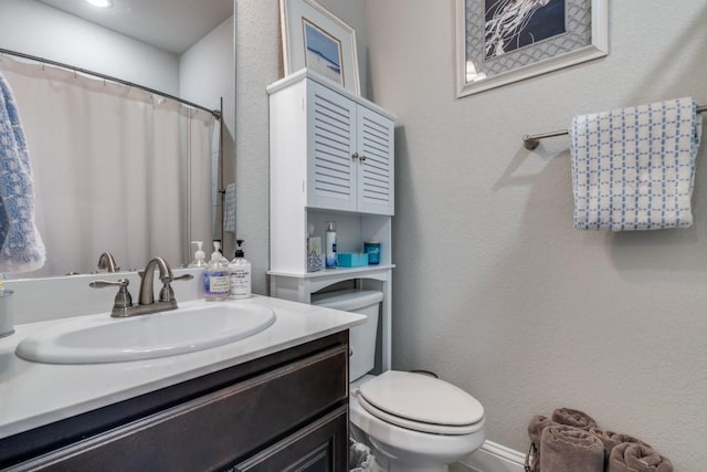 bathroom featuring vanity and toilet