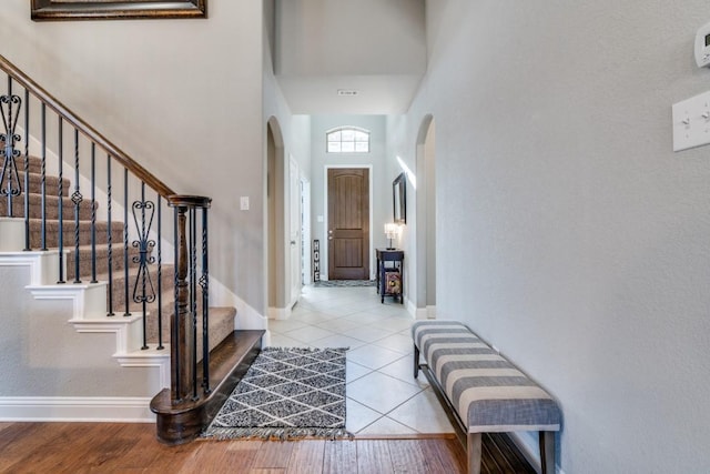 1625 Veneto Dr, Mclendon Chisholm, TX 75032 - tiled foyer featuring arched walkways, stairway, a towering ceiling, and baseboards