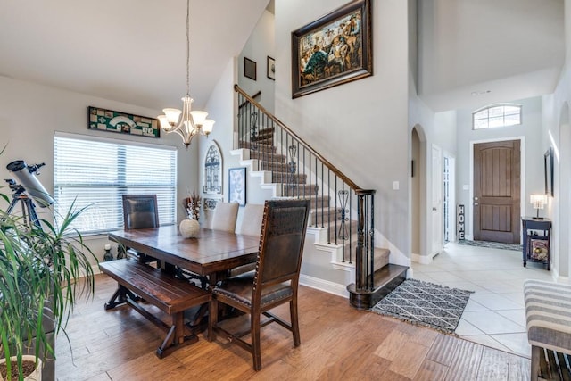 1625 Veneto Dr, Mclendon Chisholm, TX 75032 - dining space featuring stairway, a high ceiling, light wood finished floors, an inviting chandelier, and arched walkways