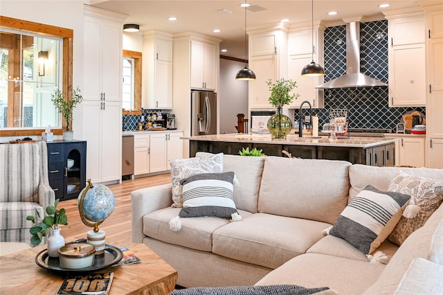 living room with light hardwood / wood-style floors and sink