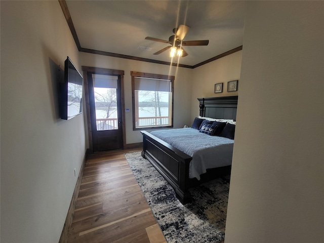 bedroom featuring ceiling fan, dark wood-type flooring, access to exterior, and crown molding