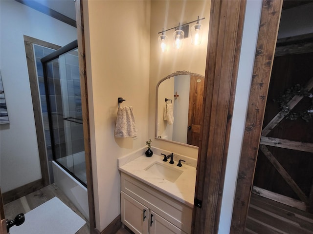 bathroom with bath / shower combo with glass door and vanity