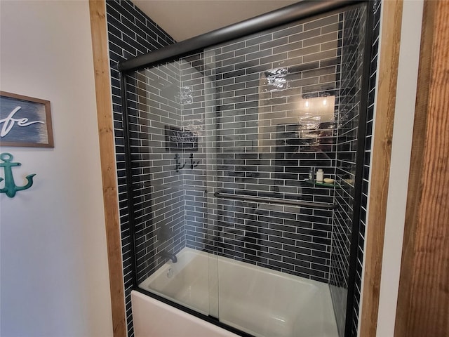 bathroom featuring shower / bath combination with glass door