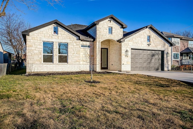 view of front of home with a garage and a front lawn