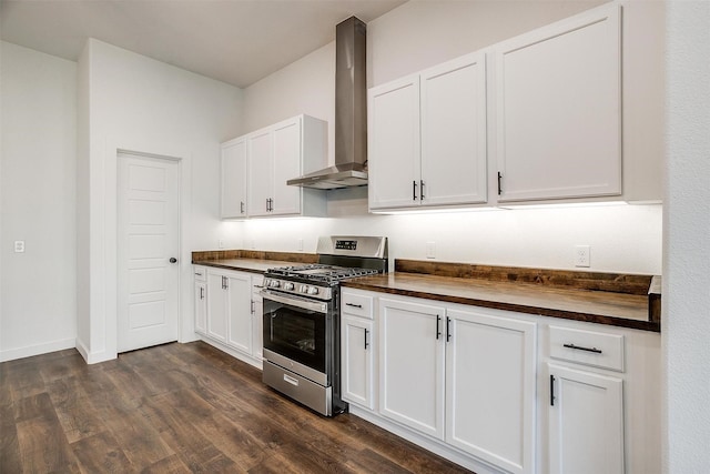 kitchen with wall chimney exhaust hood, stainless steel gas range oven, wood counters, and white cabinetry