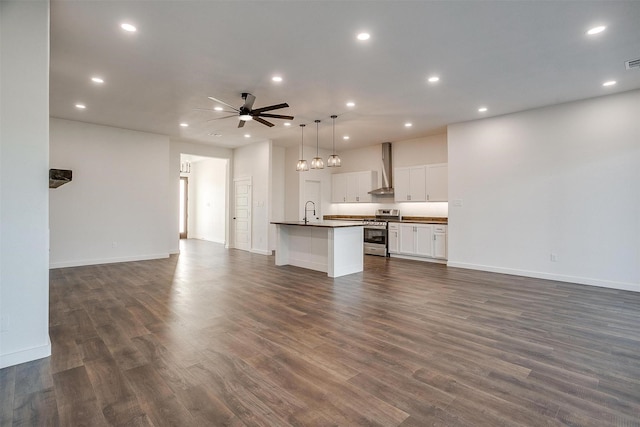 unfurnished living room with dark wood-type flooring, sink, and ceiling fan