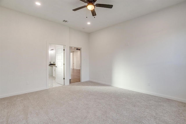 carpeted spare room with ceiling fan