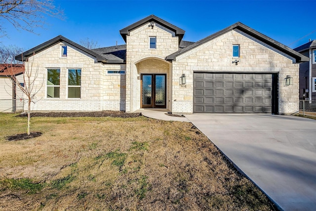 view of front of house with a front yard and a garage