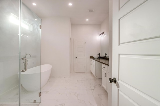 bathroom featuring separate shower and tub and vanity