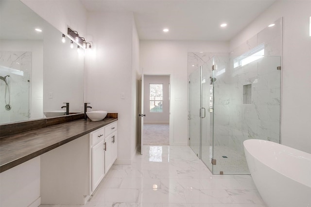 bathroom featuring vanity and shower with separate bathtub