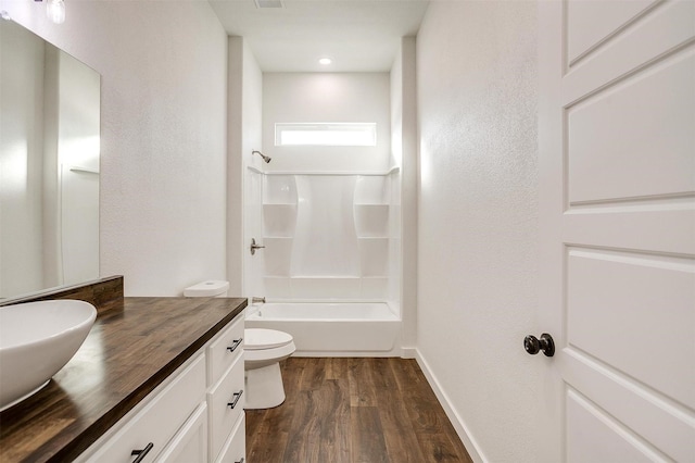 full bathroom with vanity, toilet, bathtub / shower combination, and hardwood / wood-style floors