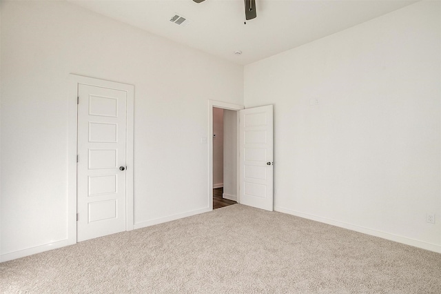 spare room featuring ceiling fan and carpet