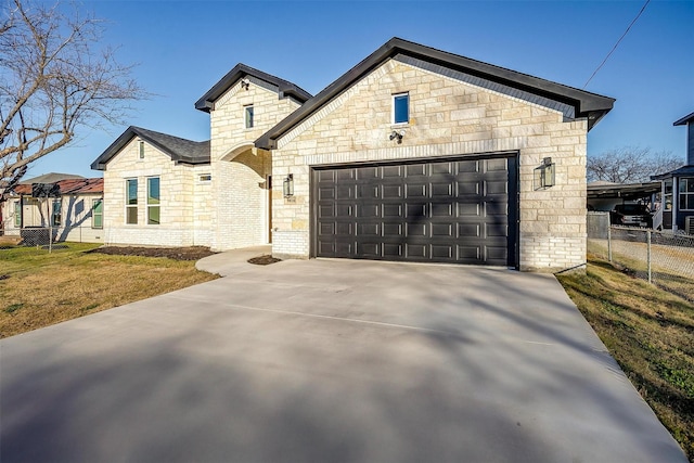 view of front of property with a garage and a front yard