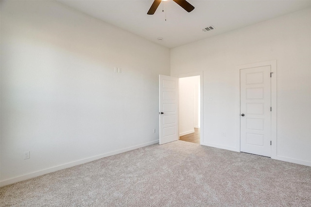 unfurnished bedroom featuring a closet, ceiling fan, and light carpet