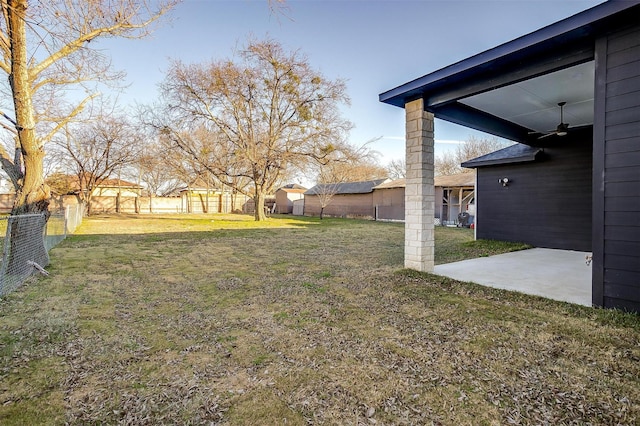 view of yard featuring a patio and ceiling fan