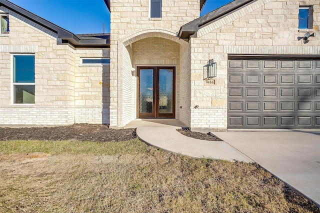 doorway to property featuring a garage and french doors