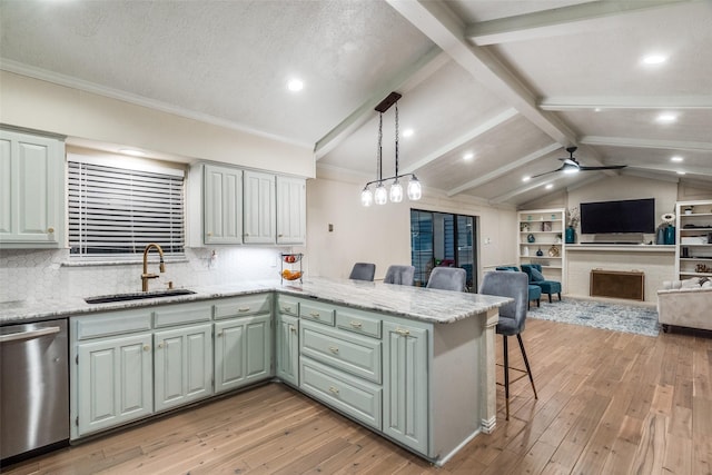 kitchen with dishwasher, decorative light fixtures, sink, kitchen peninsula, and lofted ceiling with beams