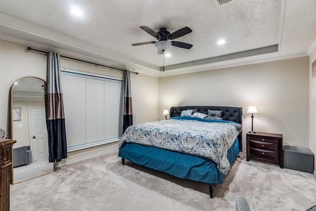 carpeted bedroom with ceiling fan, crown molding, a raised ceiling, and a textured ceiling