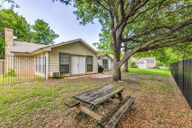 back of house with a lawn