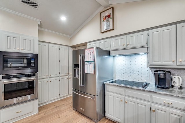 kitchen featuring light stone countertops, appliances with stainless steel finishes, vaulted ceiling with beams, decorative backsplash, and crown molding