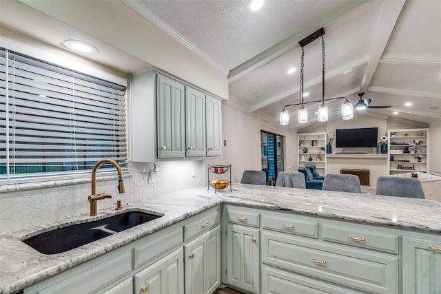 kitchen featuring kitchen peninsula, sink, vaulted ceiling, and light stone countertops