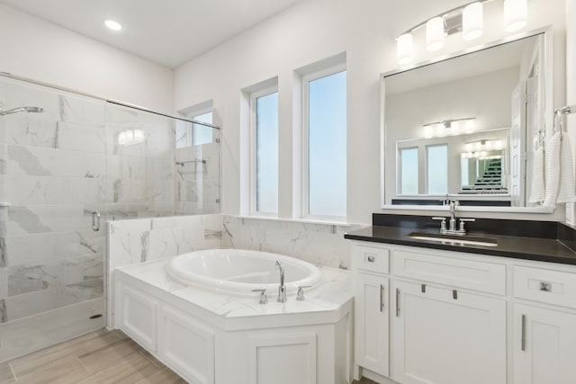 bathroom with vanity and plus walk in shower