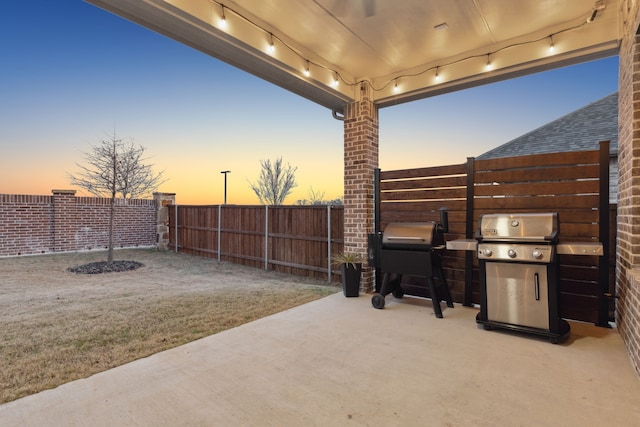 patio terrace at dusk with a grill