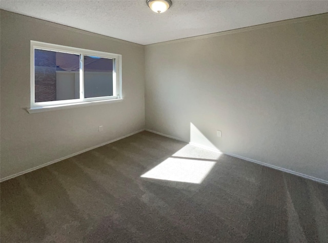 carpeted spare room with a textured ceiling