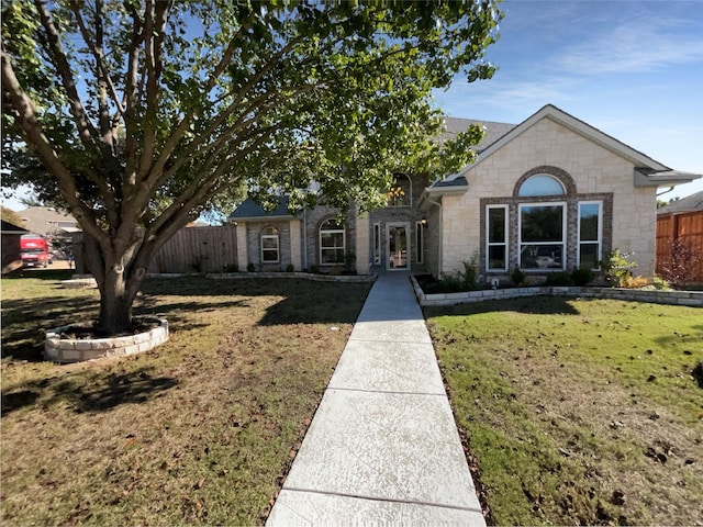 ranch-style house featuring a front lawn