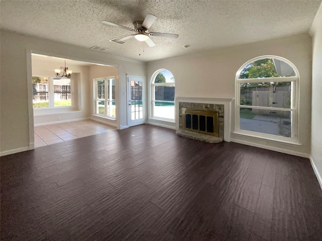 unfurnished living room with a textured ceiling, wood-type flooring, and ceiling fan with notable chandelier